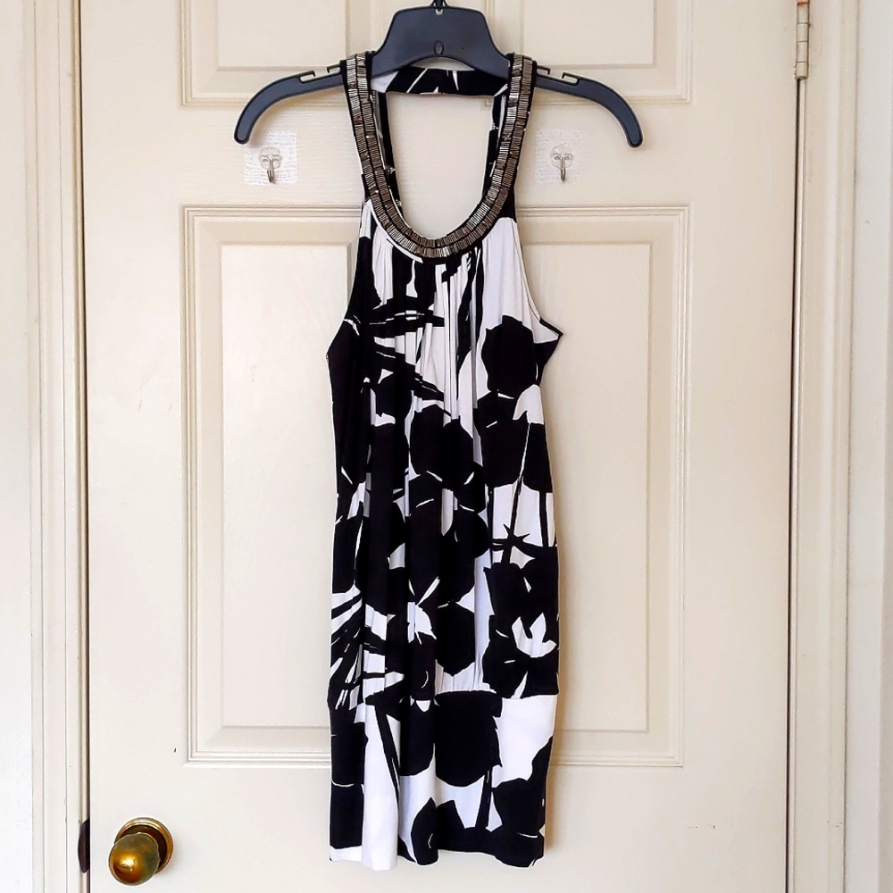 NWT. Express Rayon Black/White Floral Long top with sparkling neck decorations.